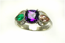 custom-designed mother's ring with cushion-cut amethyst, topaz and emerald pear-shaped gemstones, hearts and milgrain filigree details, weighted shank