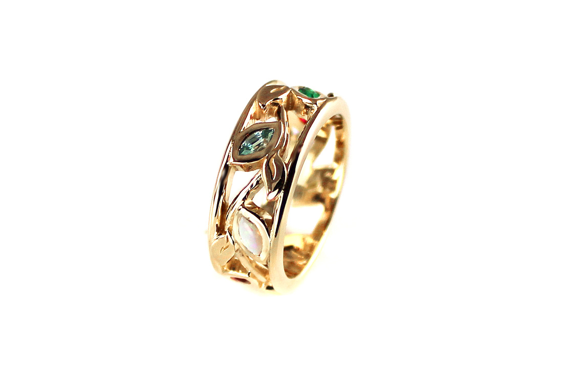 custom-designed mother's ring, 14-karat yellow gold, marquise birthstones opal, emerald, ruby, aquamarine, blue zircon, pearl, vine and leaf motif, openwork band
